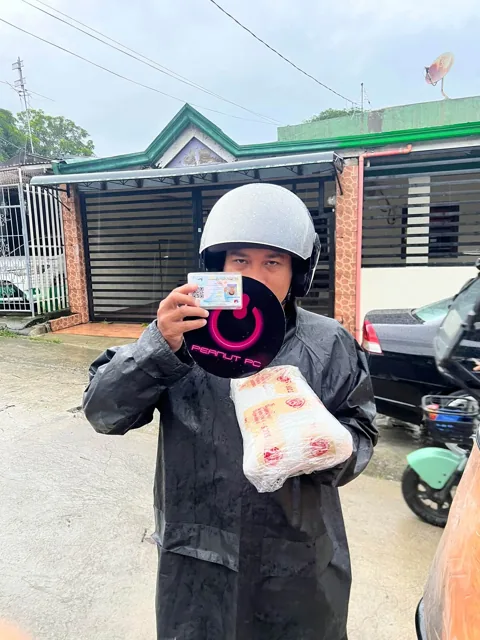 Delivery rider with a Peanut PC bag and wrapped parcel